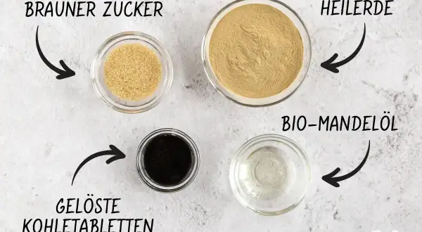 Zutaten für eine Maske gegen Pickel selber machen: Brauner Zucker, Heilerde, gelöste Kohletabletten und Bio-Mandelöl.